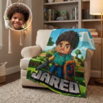 A custom personalized fleece blanket draped over an armchair in a cozy living room, featuring an 8-bit video game avatar of a young boy named Jared, alongside an inset photo showing the real-life boy it was designed for.