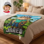 A personalized gamer kids' blanket laid on a bed, displaying a custom 8-bit avatar wearing a checkered hat and the name Jared, perfectly matching the boy wearing a checkered hat in the inset photo.
