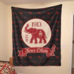 The customized Delta Sigma Theta Soror Olivia elephant blanket hung flat against a bedroom wall, doubling as a large decorative tapestry.
